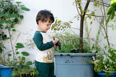 Boy playing with a stick in the garden