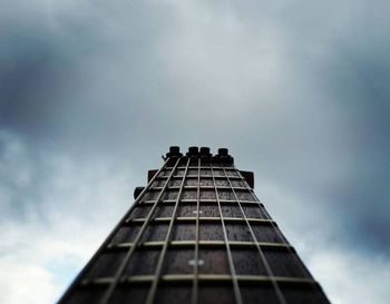 Low angle view of modern building against cloudy sky