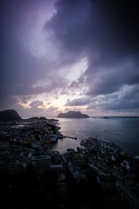 High angle view of townscape by sea against sky