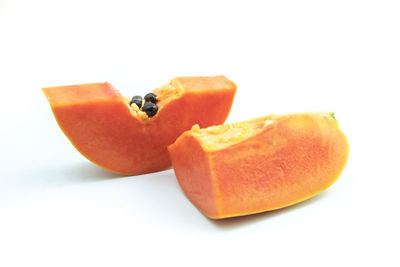 Close-up of orange fruit against white background