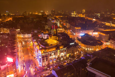 High angle view of city lit up at night