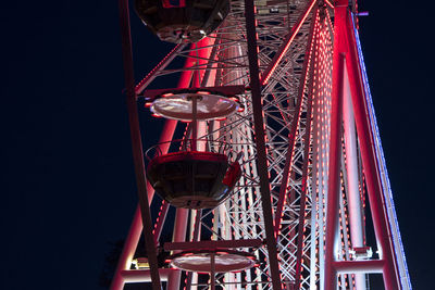 Low angle view of illuminated ferris wheel against sky at night