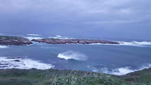 Scenic view of sea against cloudy sky