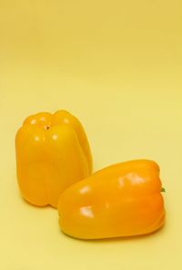 Close-up of yellow bell pepper against orange background