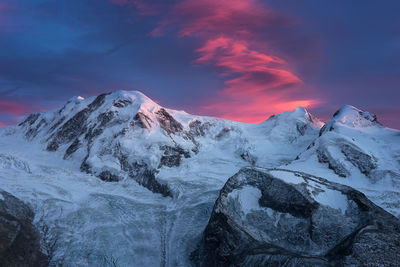 Scenic view of snowcapped mountains against sky during sunset