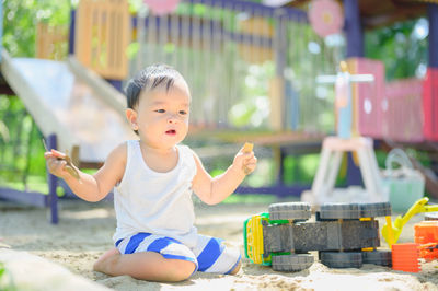 Cute boy sitting outdoors