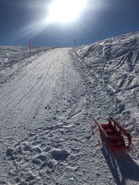 Snow covered land against sky