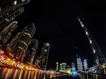 Low angle view of skyscrapers lit up at night