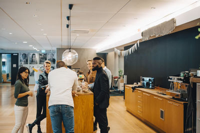 Business people discussing during meeting at cafeteria in office