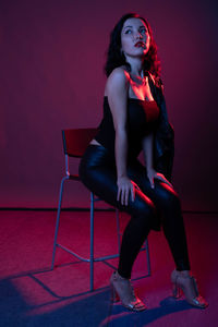 Portrait of a young woman sitting outdoors