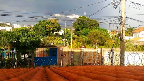 Built structure by trees against sky