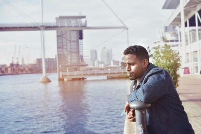 Side view of young man standing in river