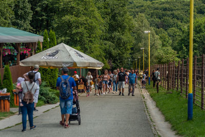 Group of people walking on street in city