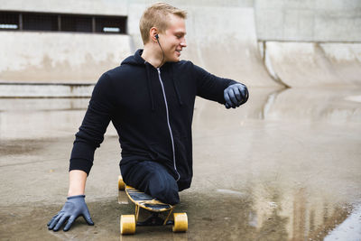 Disabled man skateboarding at park