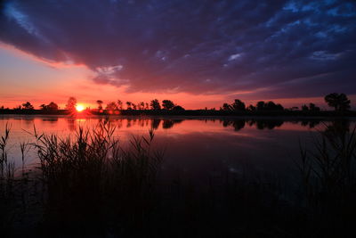 Scenic view of lake against romantic sky at sunset