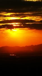 Scenic view of dramatic sky at sunset