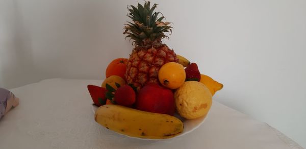 Close-up of fruits on table against white background