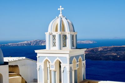 Church by sea against sky