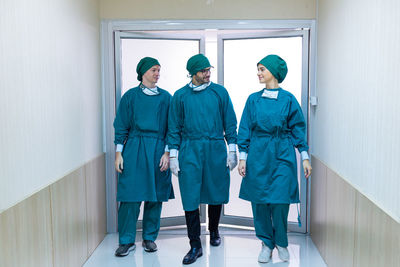 Full length of a young couple standing in corridor