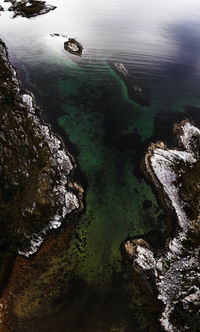 High angle view of rocks by sea