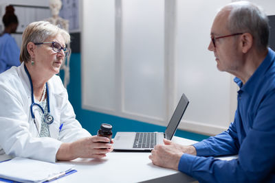 Doctor examining patient in office