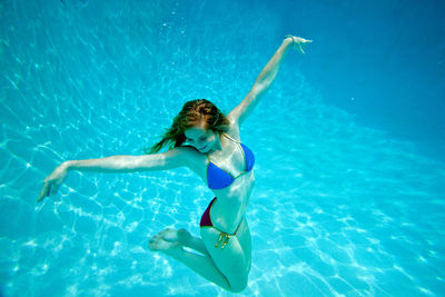 Full length of woman swimming in pool