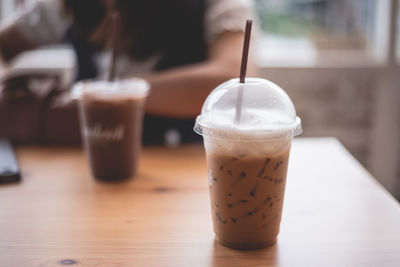 Close-up of iced coffee on table in cafe