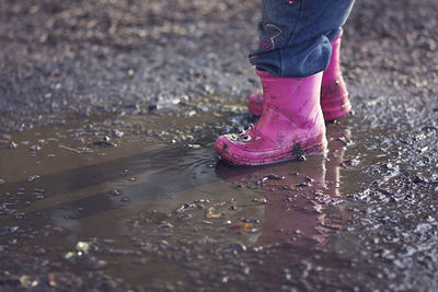 Low section of woman standing in water