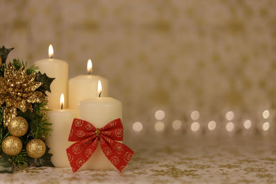 Close-up of christmas decorations with candles on table