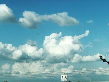 Low angle view of smoke against blue sky