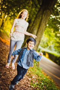 Full length of a smiling young woman outdoors