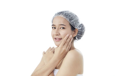 Portrait of woman against white background