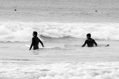 Full length of man with surfboard on beach