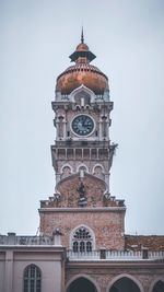 Low angle view of clock tower against sky