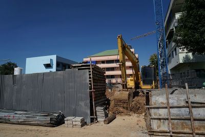 View of abandoned building against blue sky