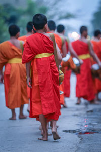 Rear view of people walking in temple