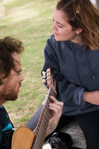 Lovely couple playing guitar and singing