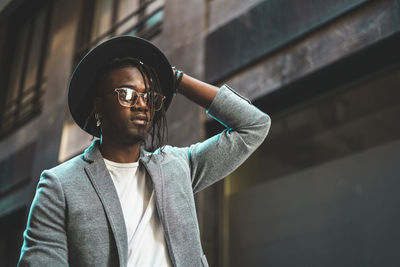 Fashionable young man standing in city