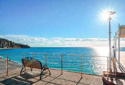 Scenic view of sea against blue sky on sunny day