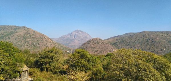 Scenic view of mountains against clear blue sky