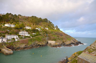 Scenic view of sea and buildings against sky