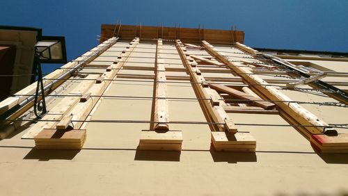 Low angle view of building against sky on sunny day