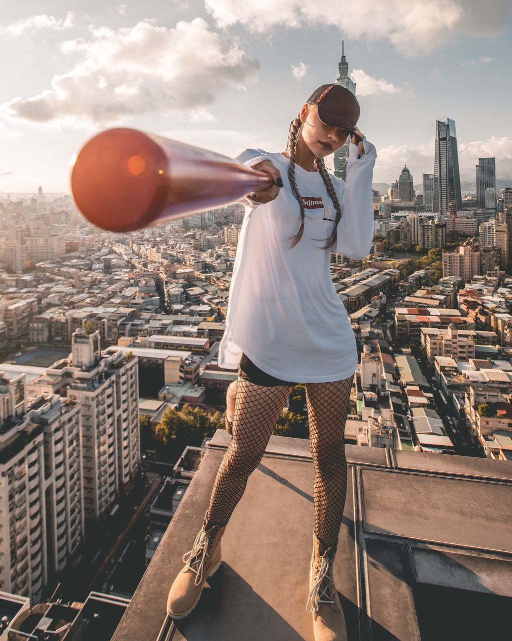 architecture, built structure, cityscape, real people, building exterior, city, one person, young adult, young women, leisure activity, outdoors, casual clothing, lifestyles, sky, full length, skyscraper, standing, day