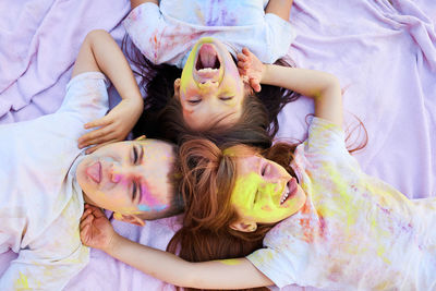 High angle view of young woman lying on bed at home