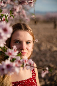 Portrait of woman with pink flower