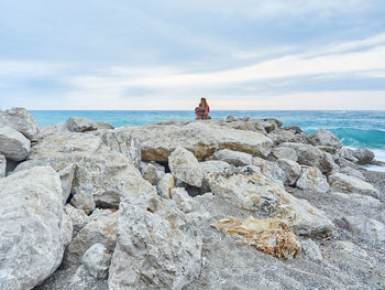 Scenic view of rocks on beach against sky