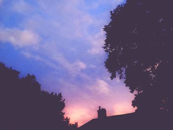 Low angle view of silhouette trees against sky