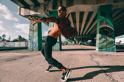 Full length of young man jumping in city