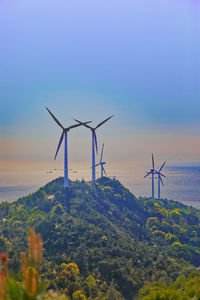 Windmill on field against sky