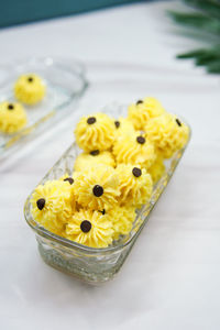 High angle view of yellow flower on table